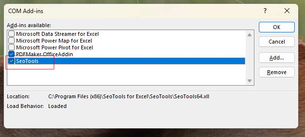 The COM Add-ins dialog with the SeoTools checkbox ticked and Load Behavior showing Loaded